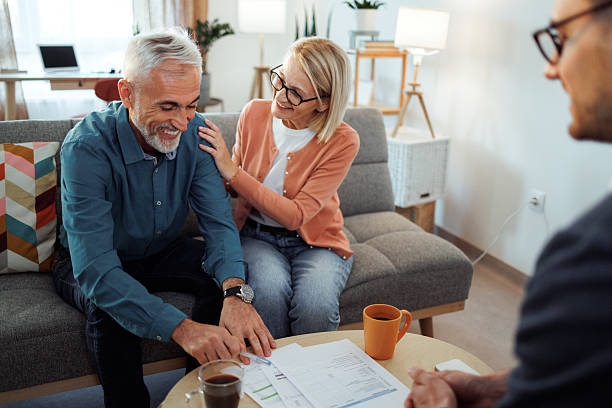 istock Mature couple signing documents with agent at home 2224698166