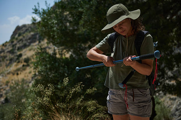 istock Woman Adjusting Trekking Pole During a Forest Hike 2224699806