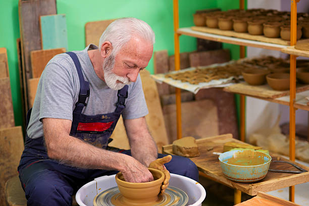 Close-up of a leather worker working on leather using crafting tools.