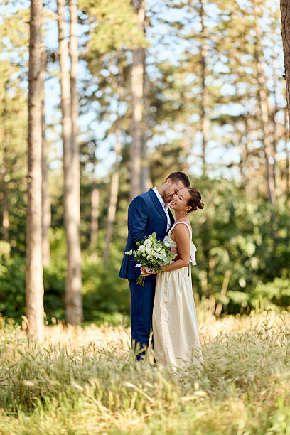 istock Bride and Groom Embracing in a Sunlit Forest During Wedding Day 2224705293