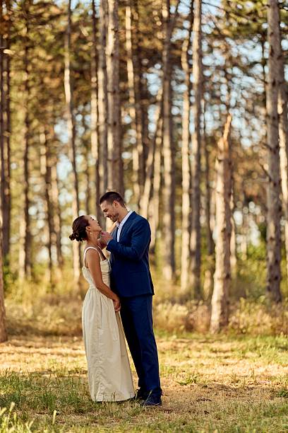 istock Romantic Bridal Couple Embracing in a Serene Forest Setting During Golden Hour 2224705303