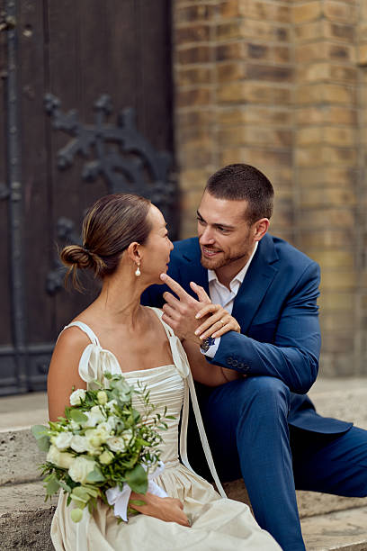 istock Smiling Couple Embracing Outside a Rustic Setting After Their Wedding Ceremony 2224705327