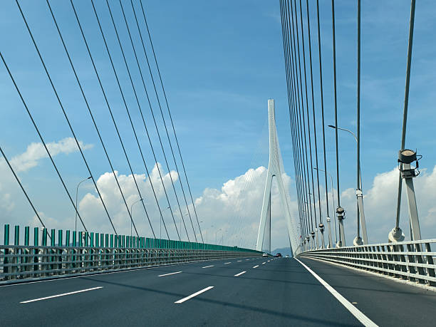 istock A Modern Bridge Under a Clear Blue Sky with Majestic Clouds and Sleek Design 2224706336