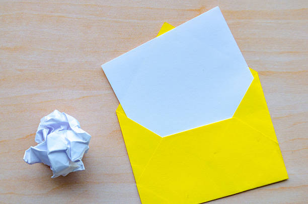 Top view of white notepad with envelope and crumpled paper with customizable space for text or ideas