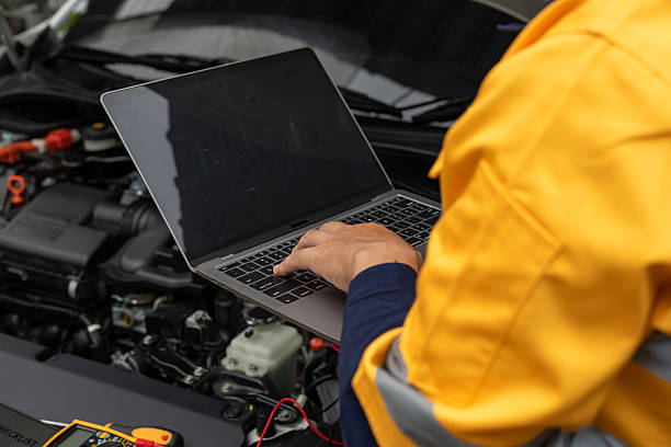 istock Mechanic using laptop for car diagnostics in garage 2224721461