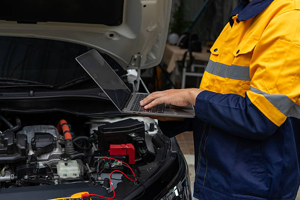 istock Mechanic using laptop for car diagnostics in garage. Modern automotive technology 2224721466