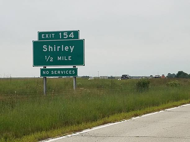 istock Green Road Exit Sign For Shirley, Illinois along the Freeway Driving Route 66 2224725669