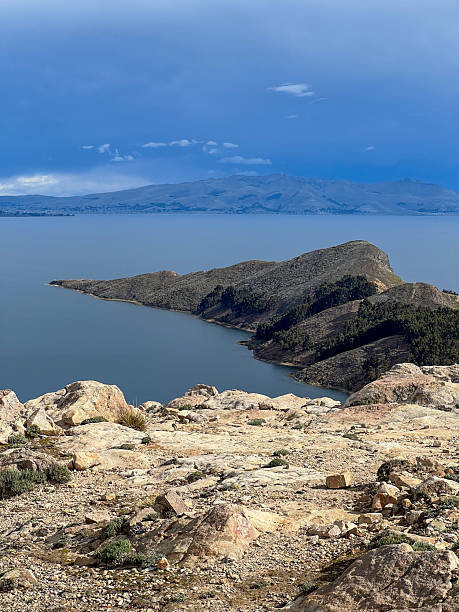 istock Rocky Peninsula Extending Into Calm Blue Lake 2224726390