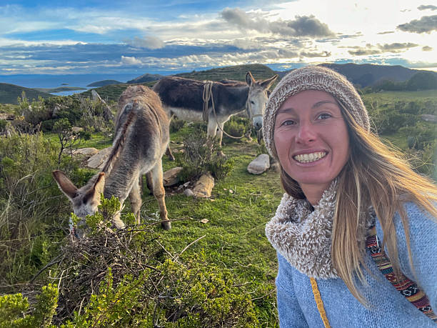 istock Woman Smiling with Donkeys in Countryside 2224726739