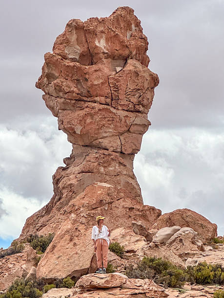 istock Woman Standing Near Large Unique Rock Formation 2224727532