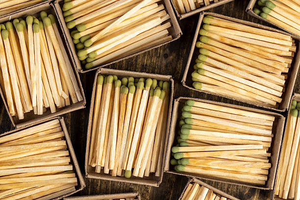 istock filling wooden matchboxes with matches with sulfur for ignition, open matchboxes with new matches made of natural wood, top view 2224728413