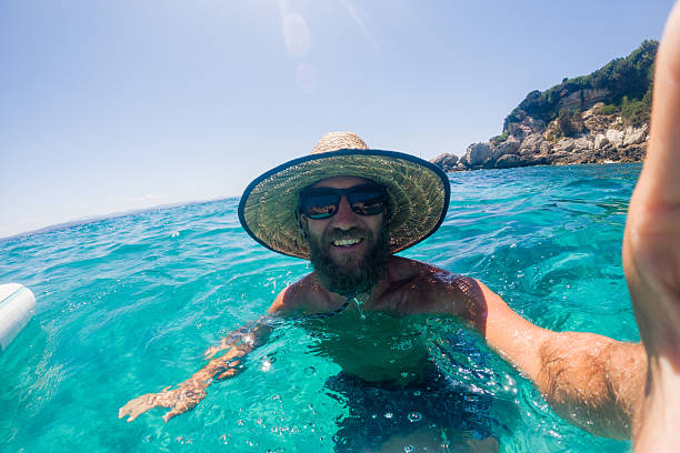 istock Man Taking Selfie Swimming in Clear Ocean Water 2224734685