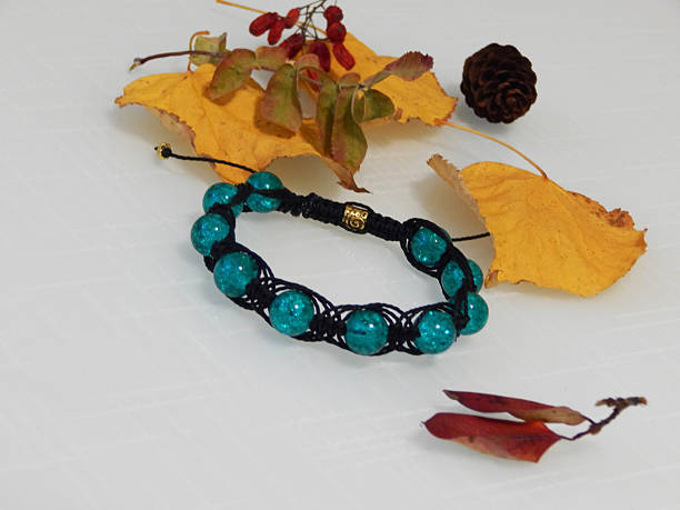 Aquamarine bracelet on a white. Hippie aquamarine bracelet and leafs