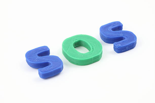 The blue and green SOS letters, highlighted by bright lighting, visually appeal as a high-urgency signal or sign.