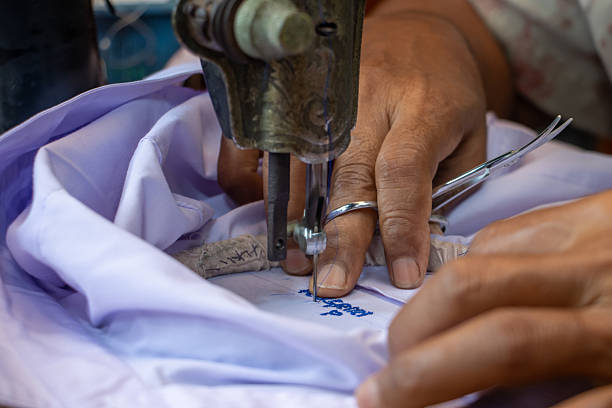 istock Embroidering Thai numbers on a student's shirt on an old sewing machine 2224736160