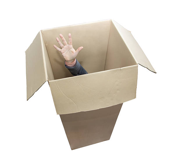 istock A man's hand raised up in a cardboard box, isolated on white background 2224736165