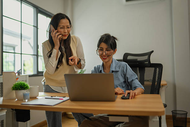 istock Asian entrepreneurs in home workspace by using laptop and smartphone with positive emotion. 2224736834