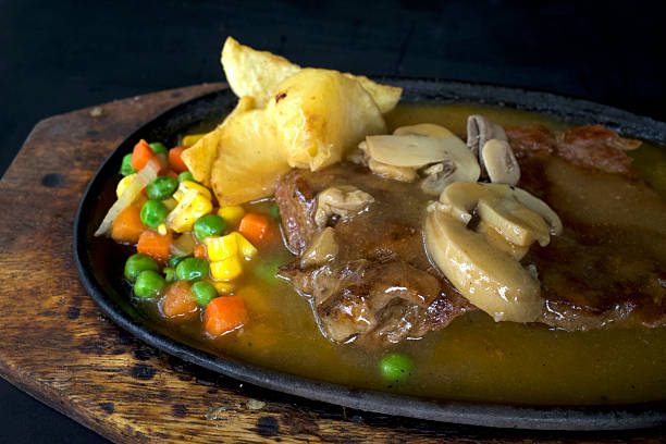 istock Beef steak with potatoes and vegetables, on wooden table 2224737616