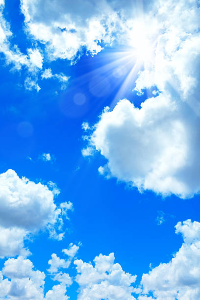 istock Full frame blue sky with shining sun and white clouds background 2224739825