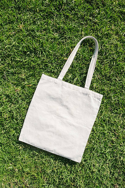 istock Canvas tote bag lying on green grass outdoor 2224740399