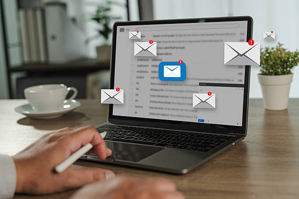 istock man reading e-mail on smartphone email inbox and email with laptop on internet information from spam mail 2224745233