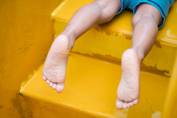 child's feet sleeping on the slide