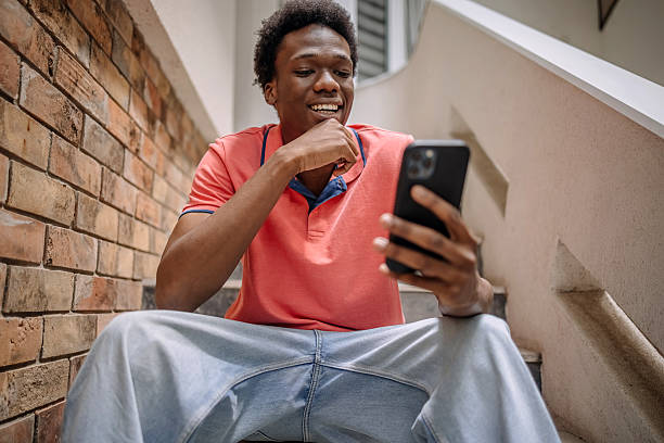 istock People feeling happiness while sitting and looking at mobile phone 2224752805