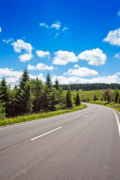 istock Curved road through green mountain landscape 2224759028