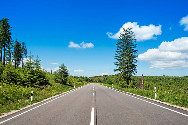 istock Asphalt road in green mountain scenery 2224759039