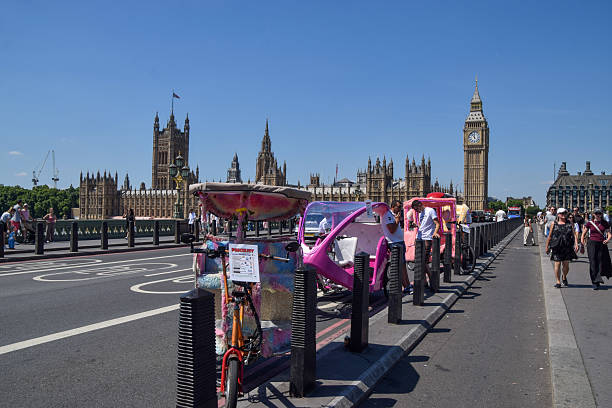 London: A Black Cab and large British Flag on The Mall Street early in the day by Buckingham Palace.