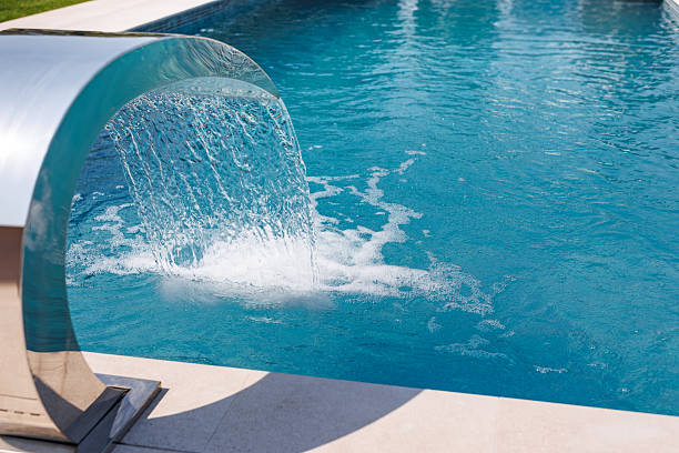 istock Modern Luxury Pool with Waterfall Feature and Clear Blue Water for Outdoor Relaxation 2224763479