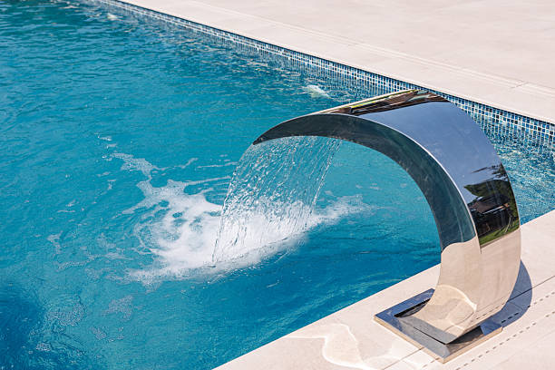 istock Modern Outdoor Pool with Elegant Waterfall Feature and Clean Blue Water for Relaxation 2224763482