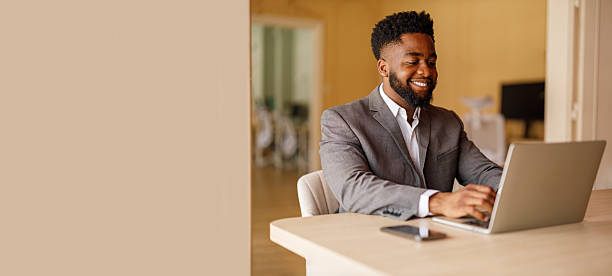 istock Portrait of confident male professional analyzing report over laptop while working in modern office 2224764314