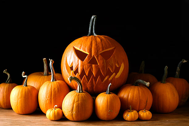 istock Cozy Halloween composition with carved jack-o-lantern pumpkin 2224766598