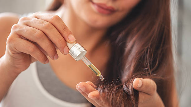 istock Applying essential oil on hair 2224767270