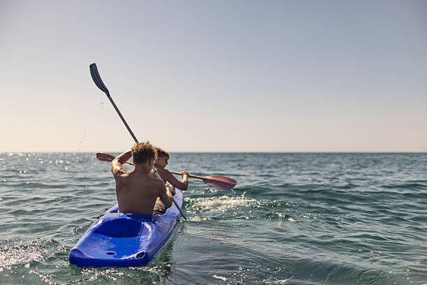 istock Two kayakers enjoying calm sea waters under a clear sky 2224771338