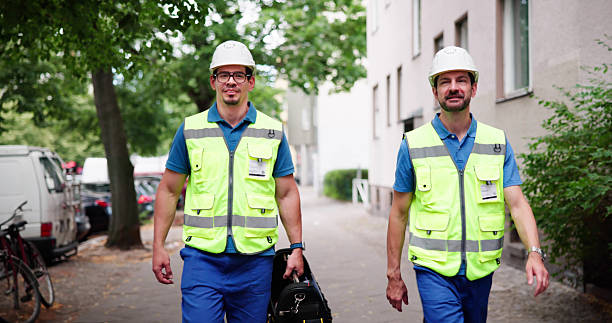 istock Smiling Repairman With Toolbox Walking 2224774583