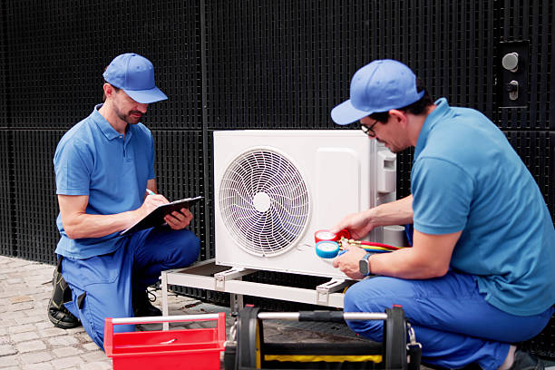 istock Repairing Electric AC Unit: Commercial HVAC Technician Ensures Proper 2224774613