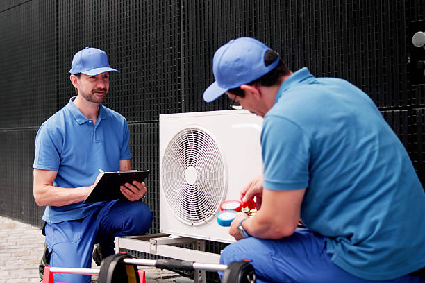 istock Hispanic Electrician Inspects Commercial AC Unit For Maintenance 2224774614