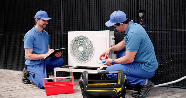 istock Hispanic HVAC Technician Inspects Commercial Air Conditioning System 2224774618