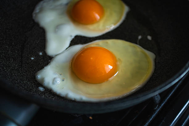istock The process of cooking scrambled eggs in a dark frying pan for a healthy breakfast. 2224775700