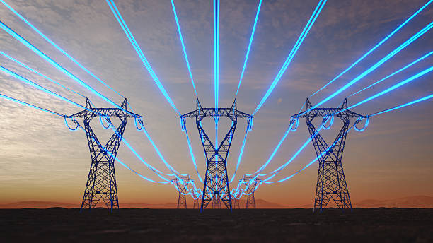 Steel transmission towers stretch across a desert plain at sunset while glowing blue strands symbolize data-intensive artificial intelligence increasing power consumption.