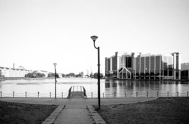istock Grainy analog view of a modern building reflected on water 2224776413