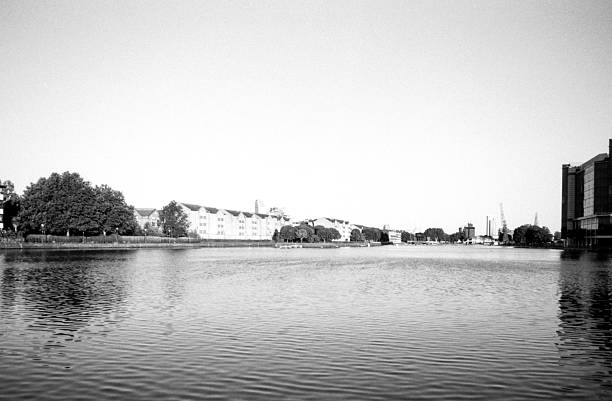 Grainy monochrome cityscape reflecting on the water