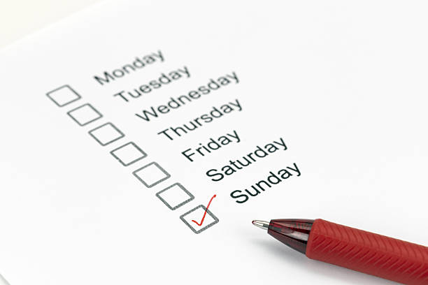 istock Checklist of weekdays with Sunday marked by red pen, indicating completion or importance. list includes Monday through Sunday, with focus on organization and planning 2224778491