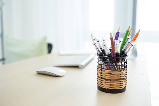 Pen holder full of pencils on isolated background