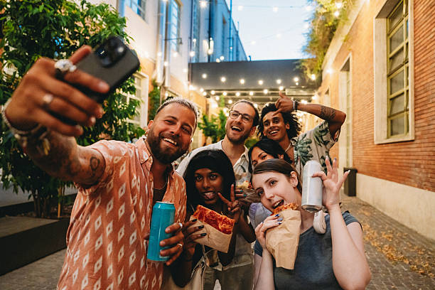 istock Friends Enjoying Night Out with Pizza and Drinks 2224782793