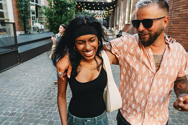istock Happy Couple Strolling Through Urban Street 2224783585