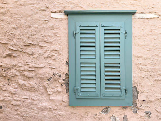 istock Closed Green Wooden Shutter on Textured Pink Wall with copy space 2224785851