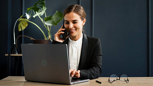 istock Stylish young woman working on a laptop in a modern office. 2224791892